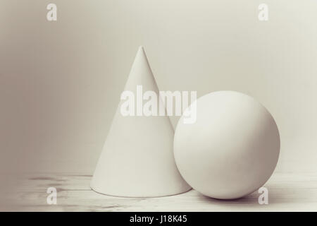 Simple geometric shapes cone and sphere. Elementary construction in art school. Stock Photo