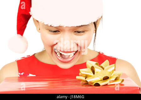 A pretty woman with a surprised look receiving christmas present Stock Photo
