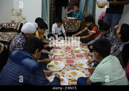 Children eating snacks birthday party, jodhpur, rajasthan, india, asia Stock Photo