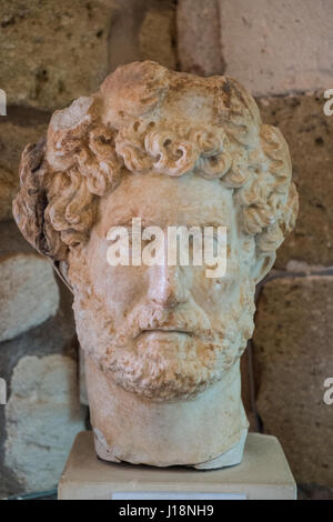 Marble bust of a man. Culture: Roman. Dimensions: H. 7 3/4 in. (19.7 cm).  Date: 3rd century A.D.. Beardless man with cloak on left shoulder. The  barely articulated hairst - Album alb3600300