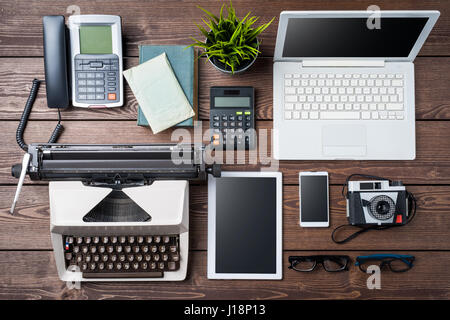 Old and modern devices on wooden table. Technology progress concept Stock Photo