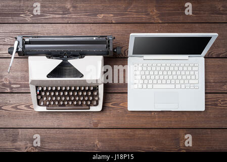 Old and modern devices on wooden table. Technology progress concept Stock Photo