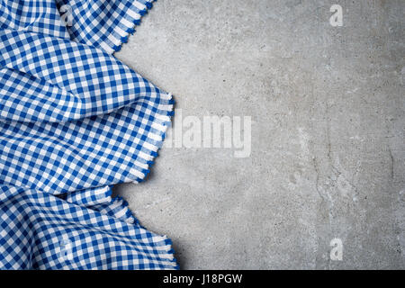 Blue folded tablecloth on gray stone table Stock Photo