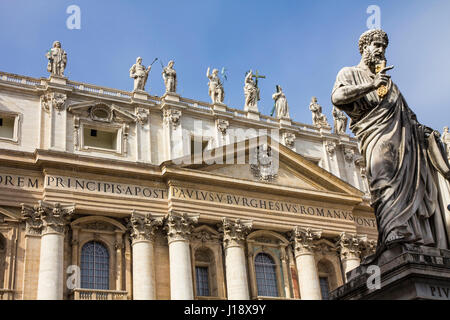 A statue of St. Peter holding the key to the kingdom stands in front of St. Peter's Basilica, Vatican City, Rome, Italy. Stock Photo
