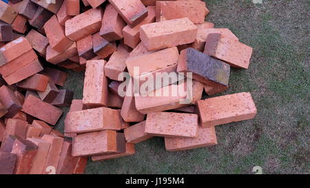 Piles of bricks on top of lawn Stock Photo