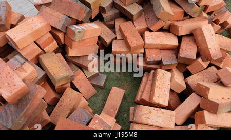 Piles of bricks on top of lawn Stock Photo