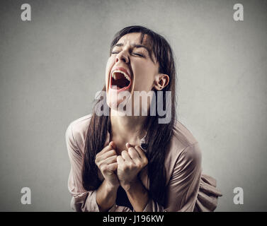 Brunette woman being scared while yelling Stock Photo