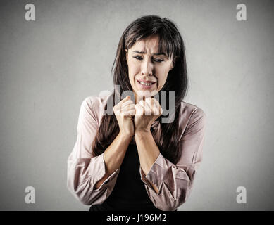 Brunette woman being scared Stock Photo