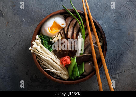 Mixed oriental mushroom stir fry with noodles soup and spring onion Stock Photo