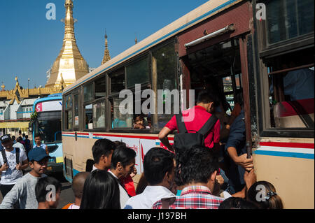 28.01.2017, Yangon, Republic of the Union of Myanmar, Asia - Passengers board a public bus in front of the Sule Pagoda in Yangon. Stock Photo