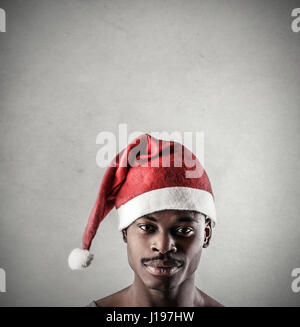 Black man in Santa hat Stock Photo