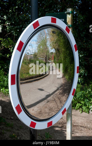 A convex road safety mirror in Middle Barton village, Oxfordshire, England, UK Stock Photo