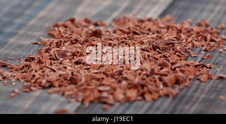 Сhocolate crumb on wooden background. Macro shot. Stock Photo