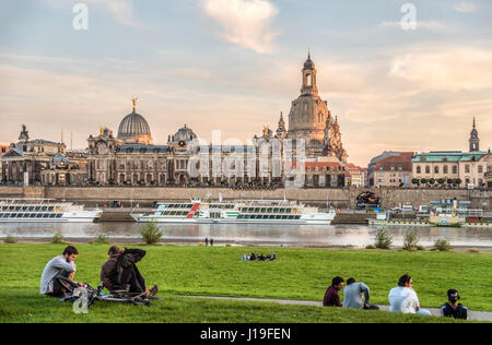 Students enjoy sunset in front the Dresden skyline, Saxony, Germany Stock Photo