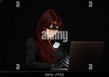 Burglar in mask at night Stock Photo