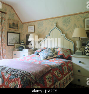 Modest retro style bedroom with patchwork quilt Stock Photo