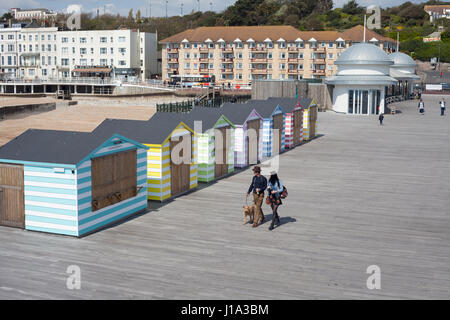 Couple walking their dog on Hastings Pier, White Rock, East Sussex, UK Stock Photo