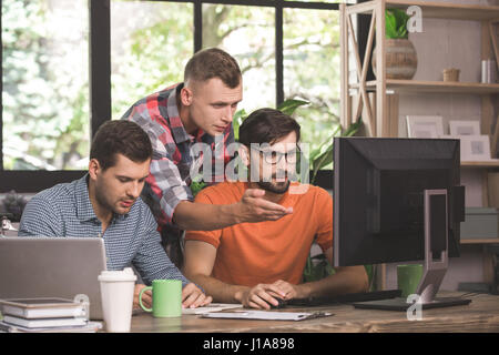 Young men programmers working together in the office  Stock Photo