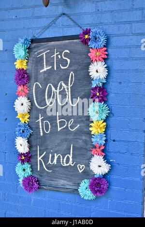 Its's cool to be kind sign spreading joy throughout the world Stock Photo