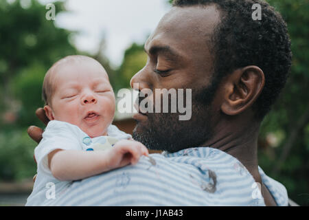 father with baby son in his arms Stock Photo