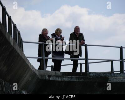 West Bay, Dorset, UK. 19th Apr, 2017. The sunny weather brings people out to enjoy the coastal seaside town and beach in west Dorset during the Easter holidays. Credit: Dan Tucker/Alamy Live News Stock Photo