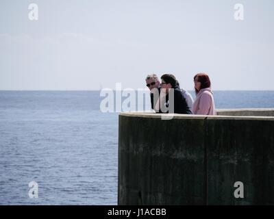 West Bay, Dorset, UK. 19th Apr, 2017. The sunny weather brings people out to enjoy the coastal seaside town and beach in west Dorset during the Easter holidays. Credit: Dan Tucker/Alamy Live News Stock Photo