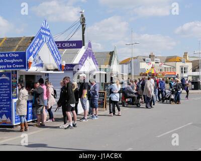 West Bay, Dorset, UK. 19th Apr, 2017. The sunny weather brings people out to enjoy the coastal seaside town and beach in west Dorset during the Easter holidays. Credit: Dan Tucker/Alamy Live News Stock Photo