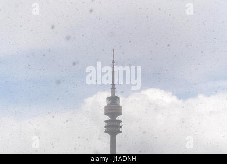 Munich, Germany. 19th Apr, 2017. Snow flakes fall in front of the Olympic Tower in Munich, Germany, 19 April 2017. Photo: Matthias Balk/dpa/Alamy Live News Stock Photo