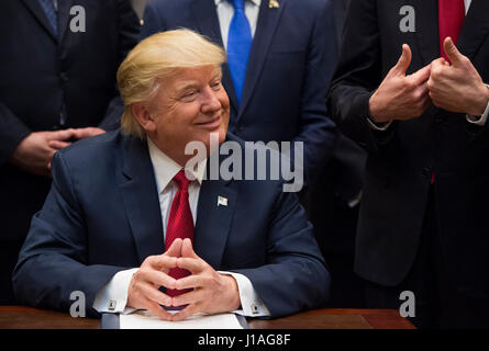 Washington, USA. 19th Apr, 2017. United States President Donald Trump listens after signing the S. 544 the Veterans Choice Program Extension and Improvement Act in the Roosevelt Room at the White House in Washington, DC on April 19, 2017. Credit: MediaPunch Inc/Alamy Live News Stock Photo