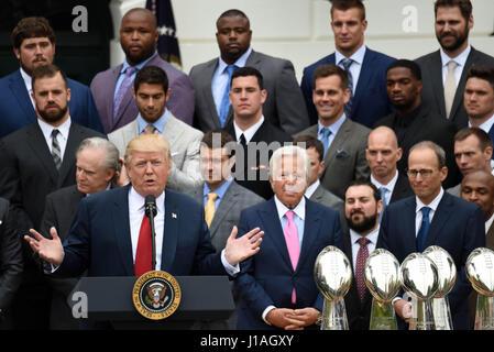 Washinton D.C., USA. 19th Apr, 2017. U.S. President Donald Trump(front L) speaks as New England Patriots owner Robert Kraft (front R) listens at a ceremony welcoming the visit of the Super Bowl Champion New England Patriots on the South Lawn of the White House in Washington, DC, the United States, April 19, 2017. Credit: Yin Bogu/Xinhua/Alamy Live News Stock Photo