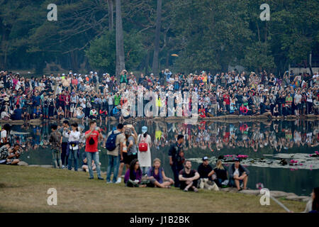 Tourists gathering to watch the sun rise at the Angkor Wat UNESCO World heritage site at Siem Reap, Cambodia. Stock Photo