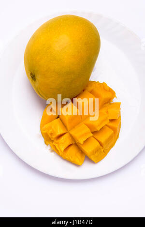 Mumbai / India  12 April 2017 Mango fruit ( cubes, slices) on the plate and butterfly isolated on white background Stock Photo