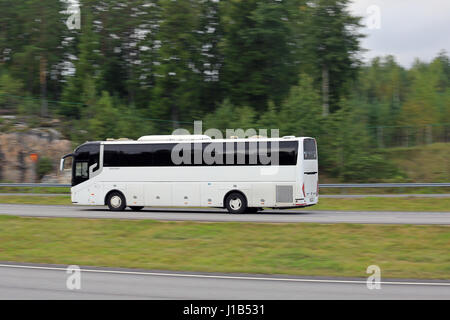 PAIMIO, FINLAND - AUGUST 26, 2016: White Chinese ZhongTongBus luxury coach at high speed on motorway in South of Finland. In-camera motion blur. Stock Photo