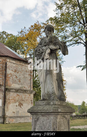 Park statue of St. Joseph baroque Roman Catholic church in Pidhirtsi, Ukraine. Pidhirtsi village is located in Lviv province, Western Ukraine. Stock Photo