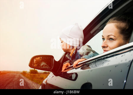 Caucasian mother and son looking out car window Stock Photo