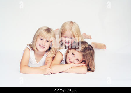 happy blonde children loving sisters sibling love, joy concept, little blonde girls family fun togetherness concept, connection concept, best friends, Stock Photo