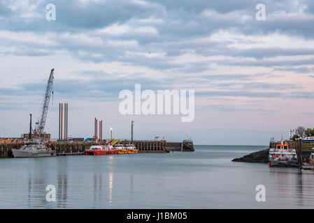 Boats in Newhaven Harbour , East Sussesx, England at sunset Stock Photo