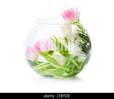 Pink and white tulips in glass vase over white background Stock Photo