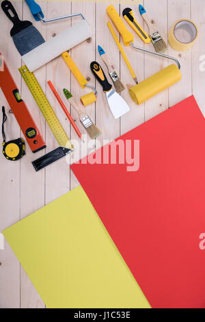 Top view of set of construction tools and colored paper on wooden table Stock Photo