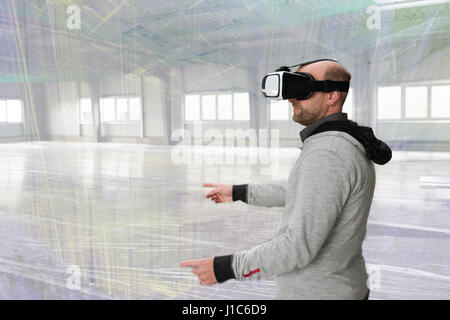 Architect with VR visor exploring industrial building environment Stock Photo