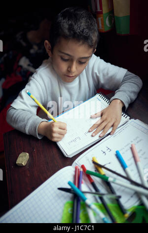 Hispanic boy practicing writing alphabet Stock Photo