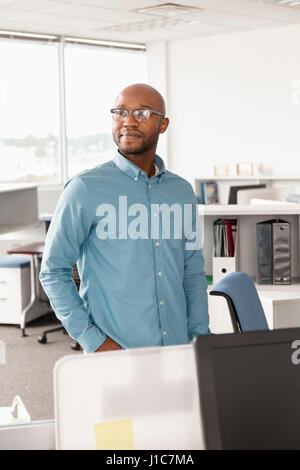 Smiling African American man standing in office Stock Photo