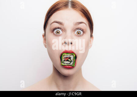 Caucasian woman with mouthful of sushi Stock Photo
