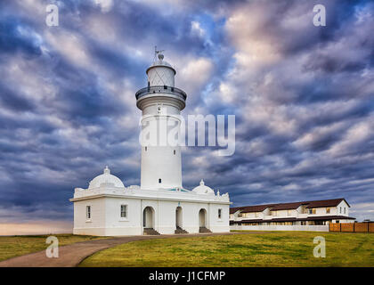WHite historic MacQuarie lighthouse on Sydney's South head Watsons bay suburb on a cloudy morning. Stock Photo