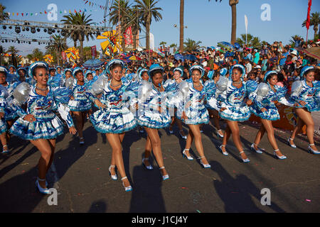 Caporales dance group in ornate costumes performing at the annual Carnaval Andino con la Fuerza del Sol in Arica, Chile. Stock Photo