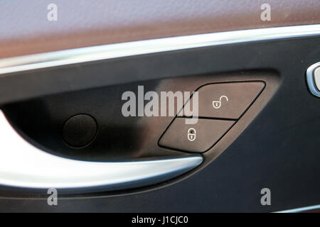 Door handle with close and open buttons in modern car interior Stock Photo