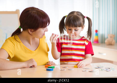 Kid playing with speech therapist Stock Photo