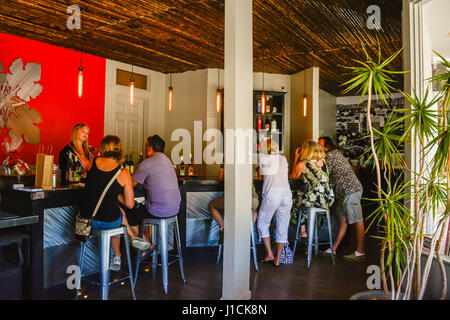 People enjoying a wine tasting at the colorful and modern tasting room at Kaena Wine bar in Los Olivos, CA in the heart of the Santa Ynez Wine Country Stock Photo