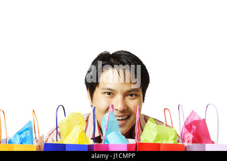 An isolated shot of young man with shopping bags Stock Photo