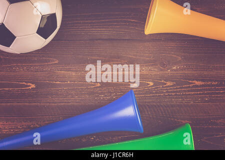 Soccer ball and Vuvuzela stadium horns on a wood background Stock Photo ...